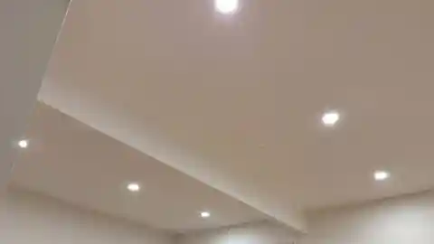 Recessed LED pot lights casting even glow in white ceiling