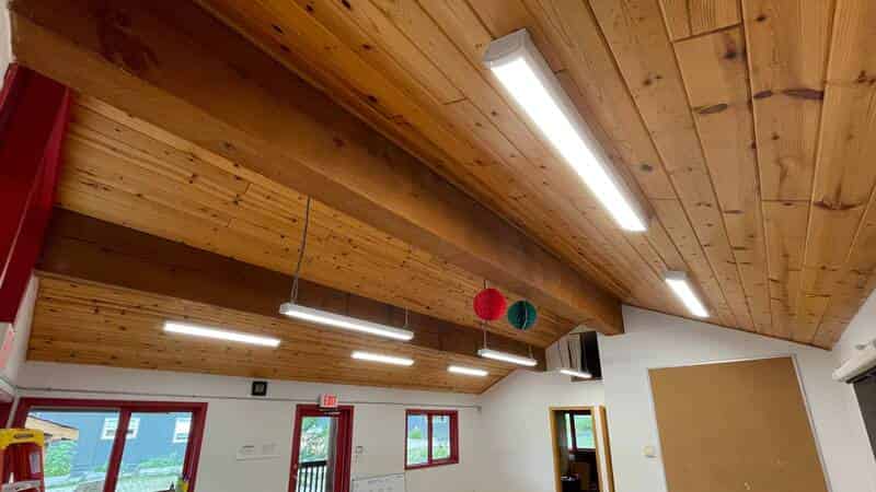 LED linear lights on wood ceiling in commercial space